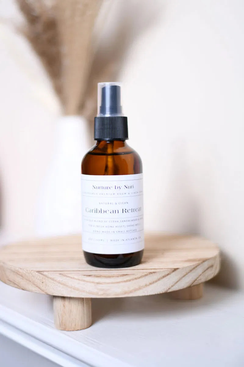 Nurture by Nuri Caribbean Retreat natural room and linen spray in an amber glass bottle