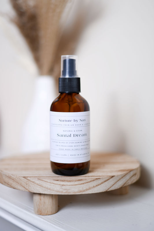 A Nurture by Nuri Santal Dream room and linen spray displayed in a warm, softly lit setting